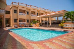 a swimming pool in front of a building at GC Resort in St Mary