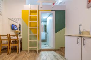 a room with a loft bed and a dining room at Paamonim Studios in Jerusalem