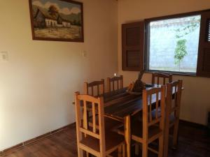 a dining room with a wooden table and chairs at B&B Pedra do Meio in Paracuru