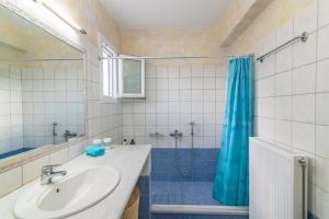 a bathroom with a sink and a shower at Anastasia Home in Triandáros