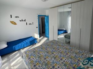 a bedroom with two beds and a mirror at Casa Scirocco in Balestrate