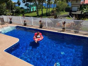 a person in a raft in a swimming pool at Ala Kai Bed and Breakfast in Keaau
