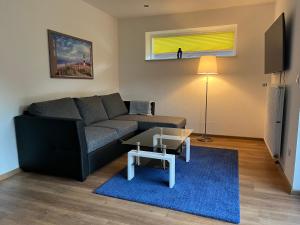 a living room with a couch and a table at Bakker Huus EG in Emden