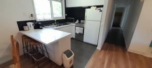 a kitchen with a white refrigerator and a wooden floor at Beauna Vista Rye Holiday Home in Rye