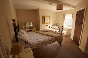 a bedroom with a bed and a window at Fitzwarine House Whittington in Whittington