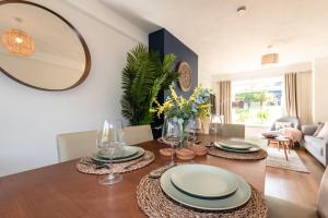 een eetkamer met een tafel en een spiegel bij 3 Bedrooms house ideal for long Stays! in Southampton