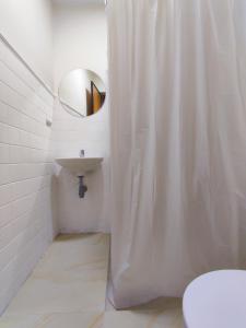 a bathroom with a shower curtain and a sink at Trip Monkey Chapinero in Bogotá