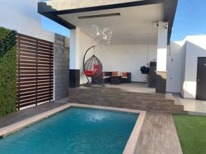 - une piscine dans l'arrière-cour d'une maison dans l'établissement Hermoso apartamento con alberca, 