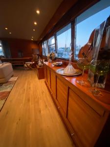 a room with a bar with wine glasses on it at Amazing boat to sleep in Barcelona in Barcelona