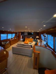 a living room with a couch and a table in a boat at Amazing boat to sleep in Barcelona in Barcelona