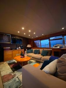 a large living room with couches and a table at Amazing boat to sleep in Barcelona in Barcelona