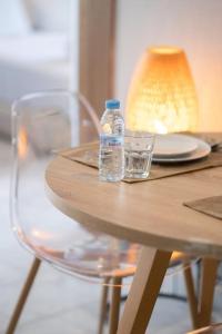 a bottle of water sitting on a table with glasses at super appartement with parking c4 in Casablanca