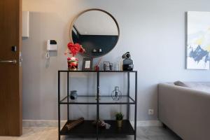 a black shelf with a mirror in a room at super appartement with parking c4 in Casablanca