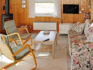 a living room with a couch and a table at 4 person holiday home in Hvide Sande in Bjerregård