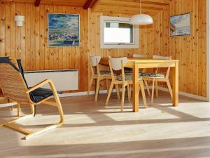 a dining room with a table and chairs at 4 person holiday home in Hvide Sande in Bjerregård