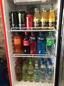 a refrigerator filled with lots of soda and drinks at Hostal D' Silvia in Arica