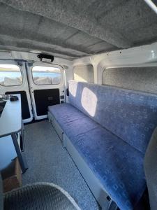 a van with a blue seat in the back of it at Cheap Camper Van in Iceland in Reykjavík