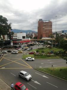 a parking lot with cars in a city at San Diego aparta estudios in Medellín