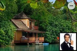 a house in the water with a picture of a man at A Piece of Paradise in Content