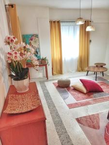 a living room with red furniture and flowers on the floor at Rumah Penangkap Mimpi in Kertih