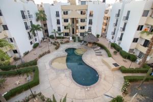 einen Blick über einen Pool in der Mitte eines Gebäudes in der Unterkunft Your Cabo Penthouse Escape Walk to Sand & Sea! in Cabo San Lucas