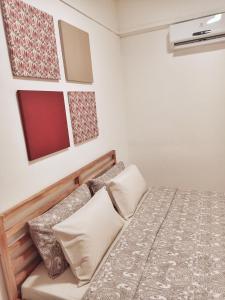 a small bedroom with a bed and a red window at Rumah Penangkap Mimpi in Kertih