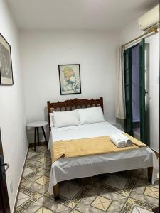 a bedroom with a bed in a room at Tamboleiro's Hotel Residence in Salvador