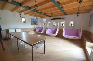 a room with a table and purple chairs at Agriturismo Prato degli Angeli in Sassoleone +209 photos