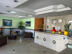 a lobby with a bar in the middle of a room at Pousada Ferreira III in Aracaju