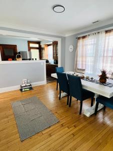 a living room with a dining room table and chairs at Dale Ave second floor in Richmond Heights