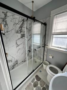 a bathroom with a shower and a toilet at Dale Ave second floor in Richmond Heights