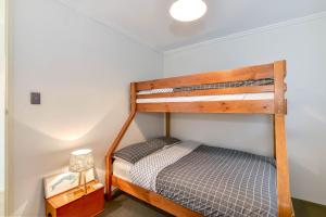 a bedroom with a bunk bed in a room at Regency Court Absolute Beachfront in The Entrance