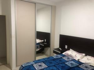 a bedroom with a bed and a large mirror at punto de encuentro in Corrientes