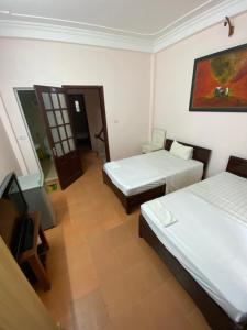 Katil atau katil-katil dalam bilik di Hoàng Kiên Hotel