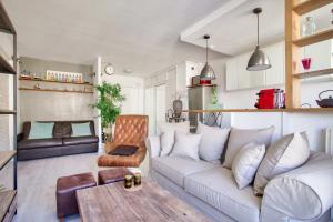 a living room with a couch and a table at Studio Republique Pierre Levé in Paris