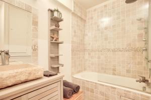 a bathroom with a tub and a sink and a shower at Studio Republique Pierre Levé in Paris