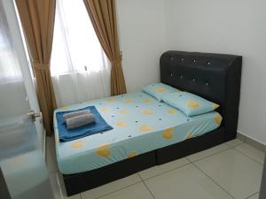 a small bed in a room with a window at FZ Almyra Homestay in Kajang +14 photos