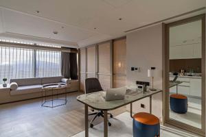 a living room with a table with a laptop on it at Hanns House in Taipei +24 photos