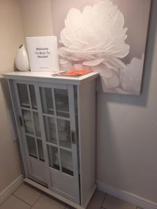 a white cabinet with a flower on top of it at Born to Wander in Cedar City