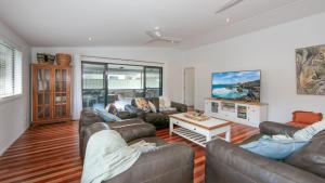a living room with two couches and a table at Hamilton House in Yamba