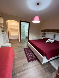 a bedroom with a large bed and a pink lamp at B&B La Dolce Sosta in Fonni