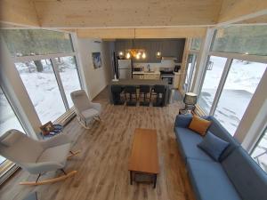 an aerial view of a living room with a couch and chairs at Les Chalets Double K # 1 in Saint-Alexis-des-Monts