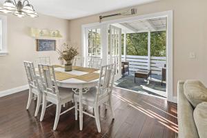 a dining room with a white table and chairs at Casa Arena Relaxing Beach House w/ Patio in Vero Beach