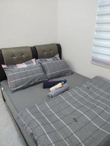 a bedroom with a bed with a gray bed frame at Wanna Homestay in Jertih