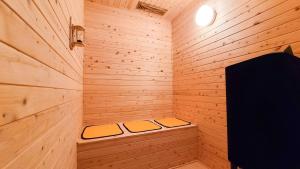 a small wooden sauna with two beds in it at 暖炉之宿 コンセプトハウス星田 in Katano