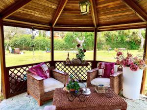 a gazebo with two chairs and a table at Espléndido dormitorio en Suite in Fuente el Saz