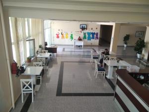 a room with tables and a person sitting at a table at Arena Hotel Balakan in Balakǝn