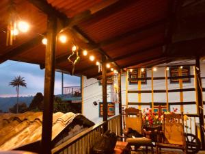 a house with a porch with lights on it at Hostal Salento Sunset in Salento