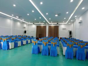 um quarto grande com cadeiras azuis com estrelas amarelas em Khách sạn Vườn Cau & Khu vui chơi giải trí SaLa em Tây Ninh