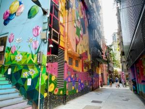 a street scene with graffiti on a wall at Ramada Hong Kong Harbour View in Hong Kong